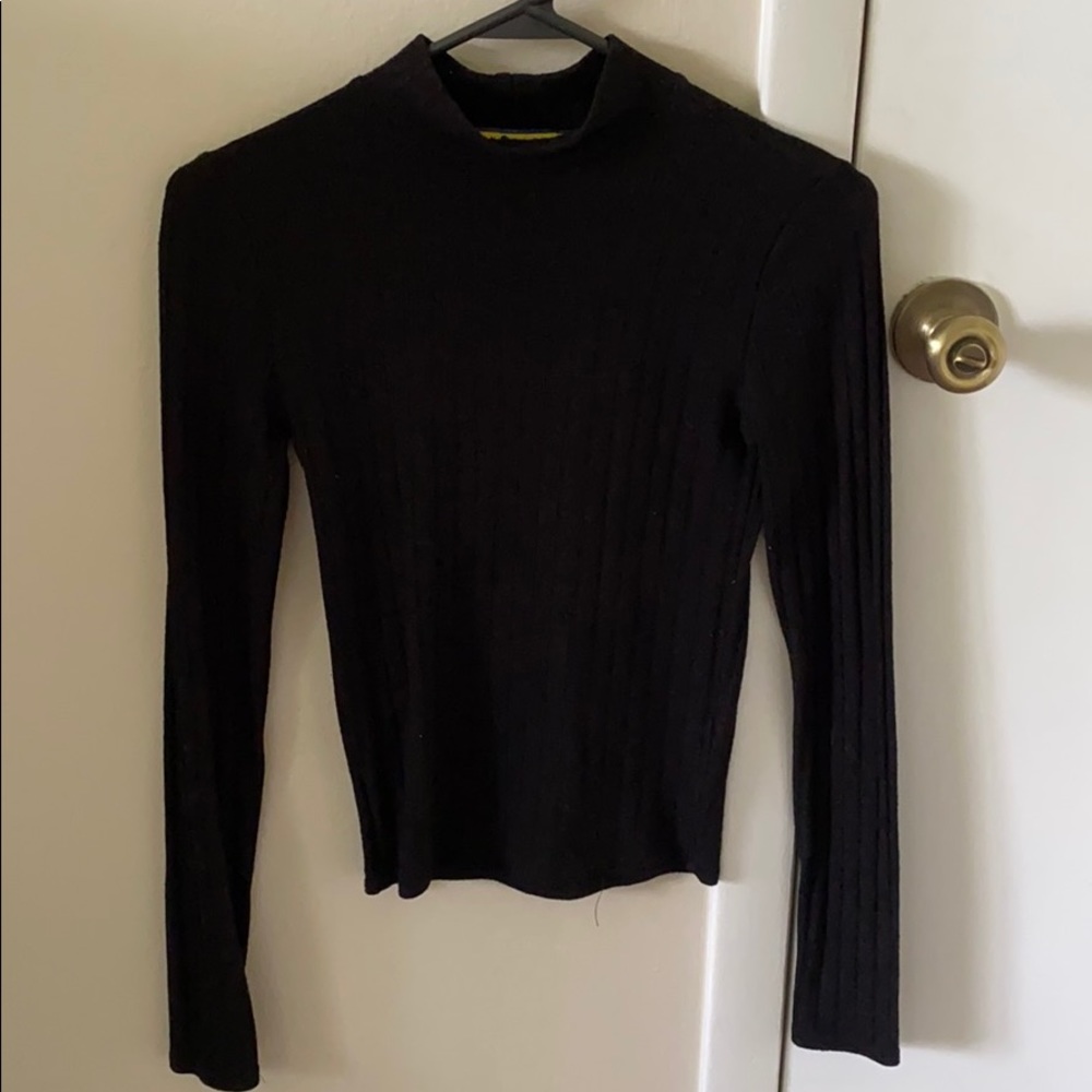 Black tight fitting turtle neck sweater